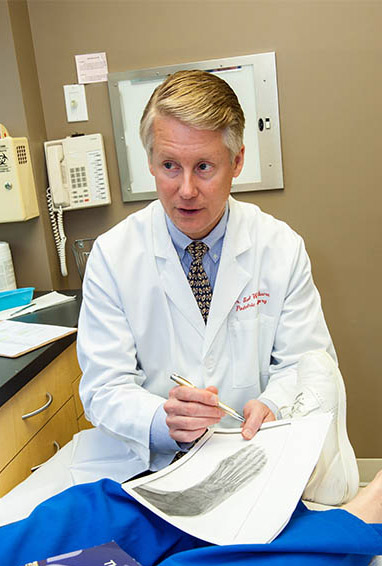 doctor prepping patient for foot surgery in the hospital - MVS Podiatry Associates